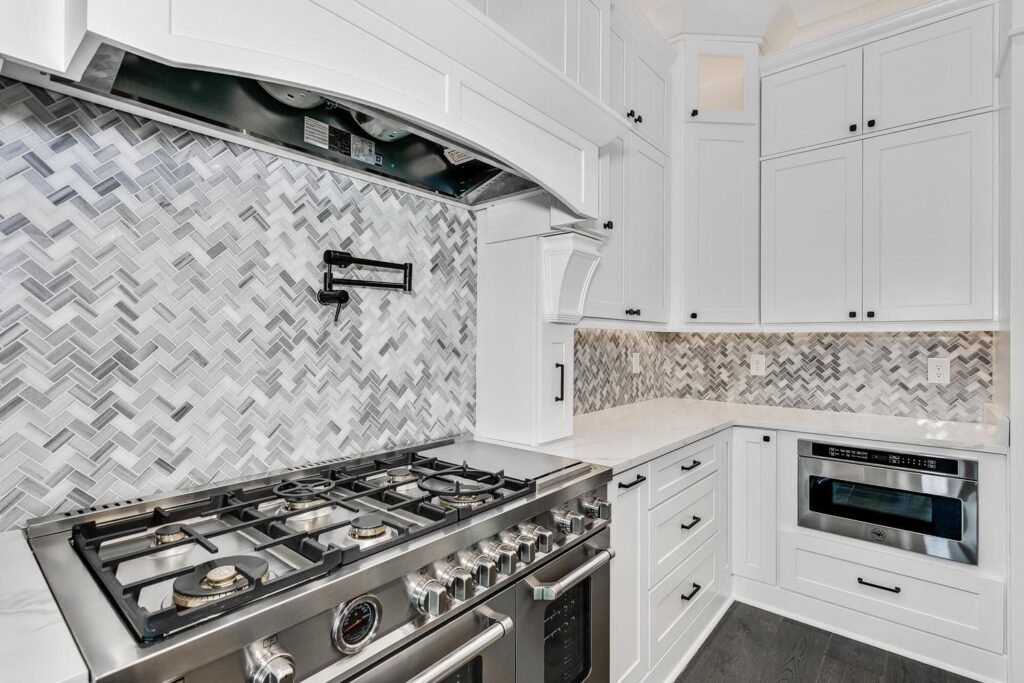 A luxury kitchen with under-cabinet lighting and a gas rangetop