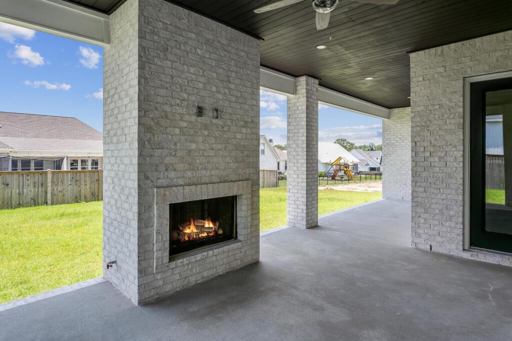 An outdoor fireplace in a covered porch