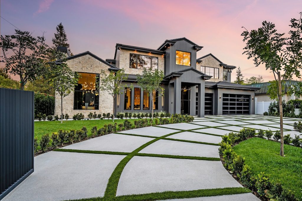 A luxury custom home with a unique driveway.