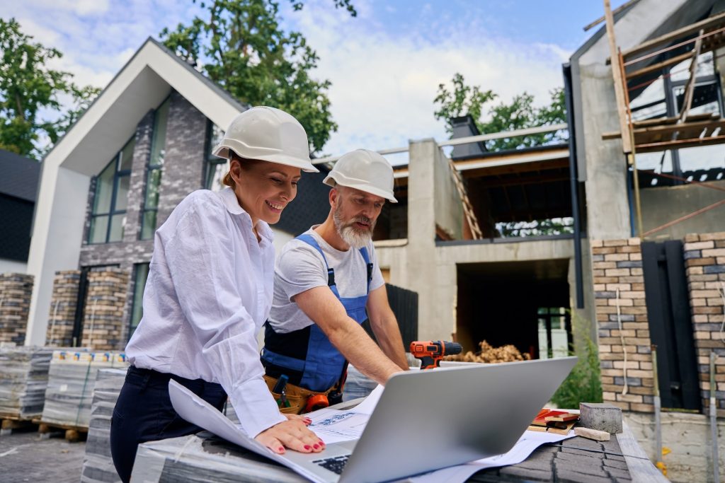 Professionals discuss the plans for a custom home.